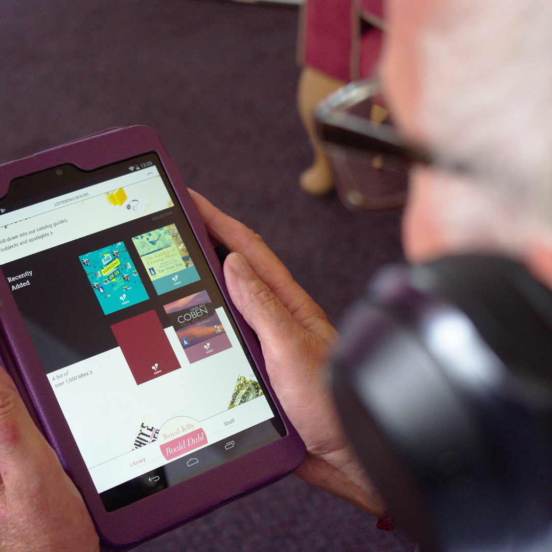 Overshoulder shot of a tablet, user is looking at the Libby app